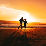웰니스 문화, 일상에서 실천하는 작은 변화가 가져오는 큰 행복 a couple of people running on a beach at sunset