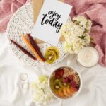 “일상 속 웰니스 문화, 작은 변화에서 시작된다” enjoy today poster on white basket beside bowl of food